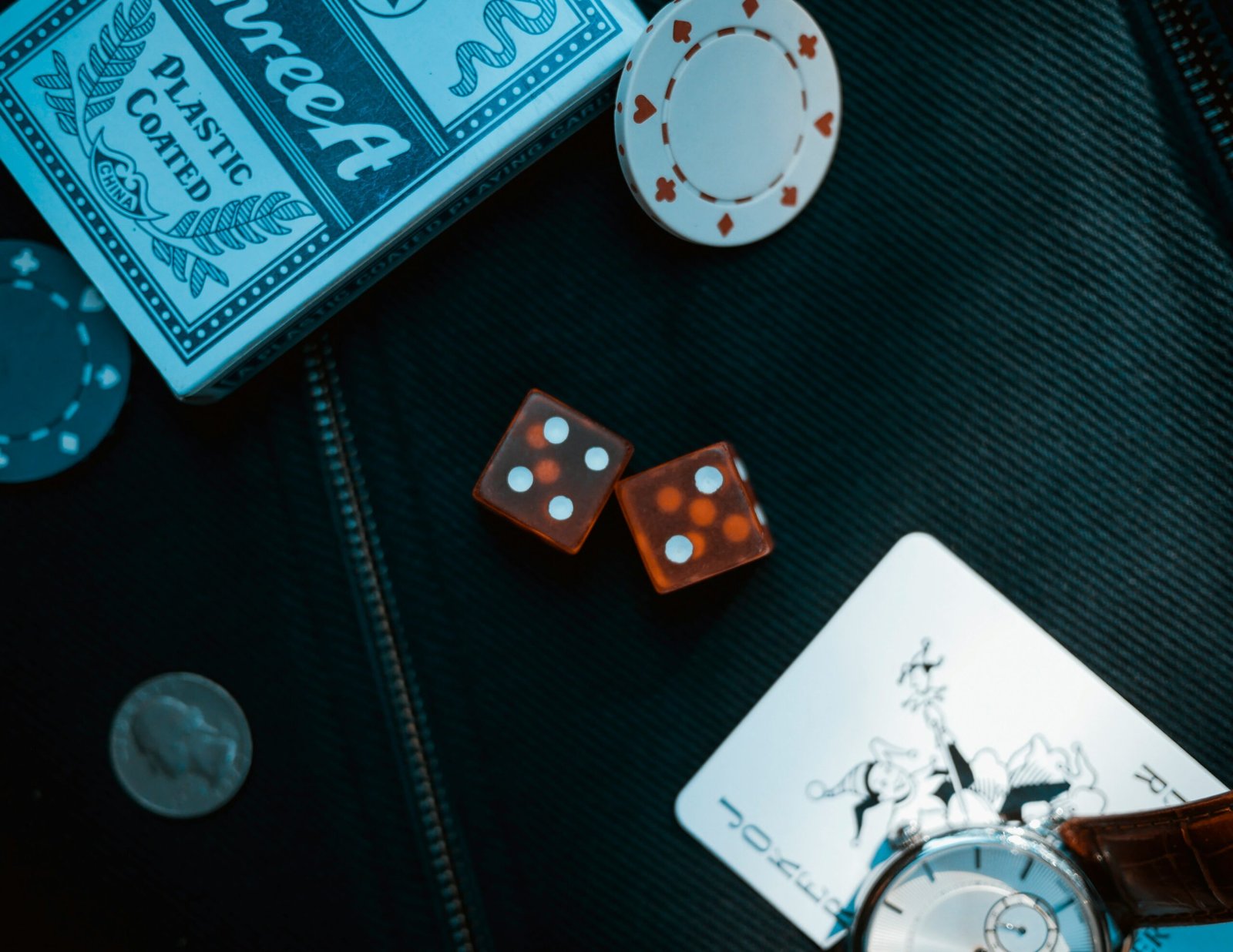 two orange dice on black surface